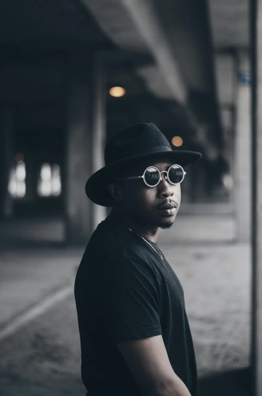 the young man is wearing a hat, sunglasses and a hat