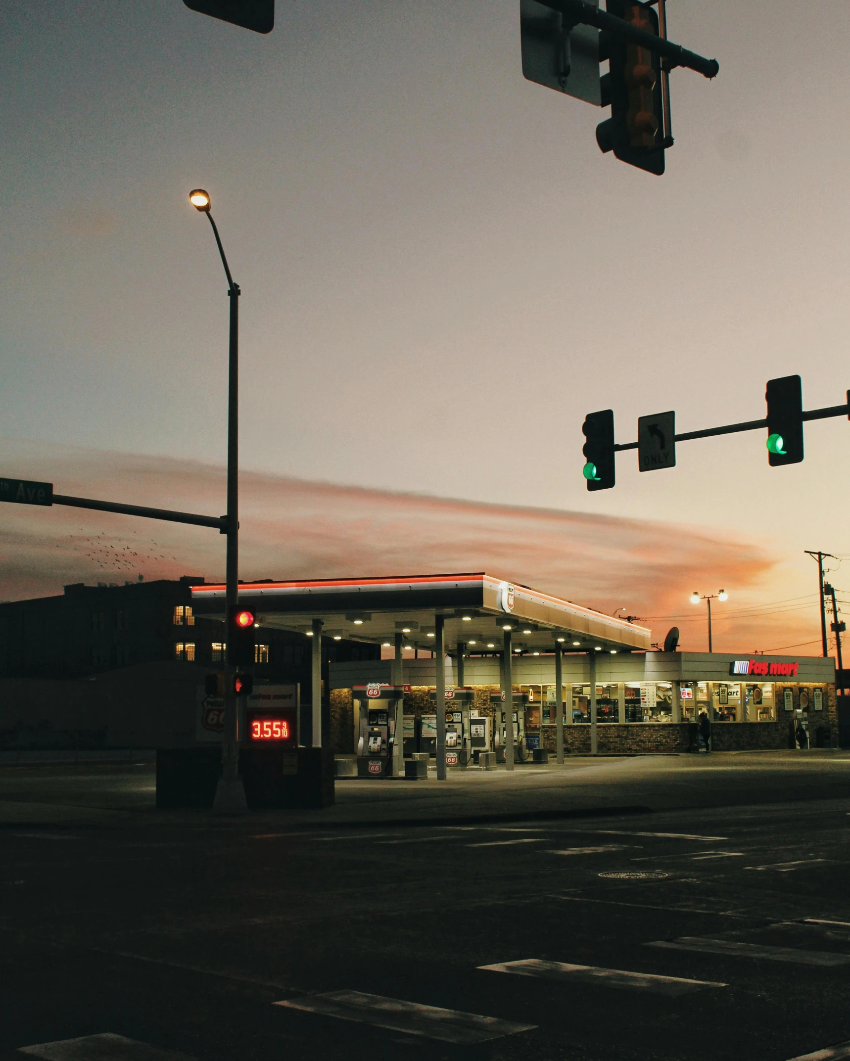 a bus traveling through a city at a gas station