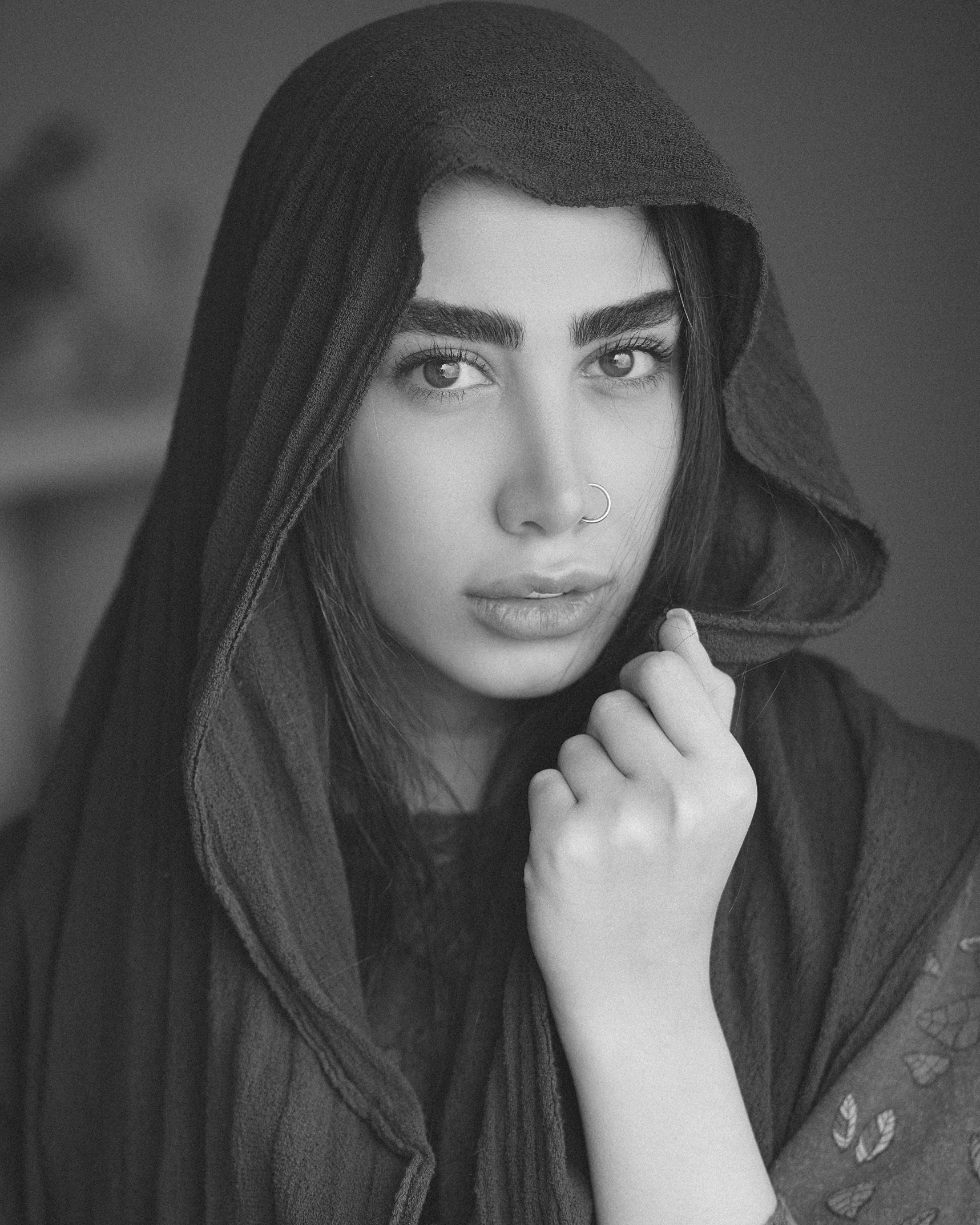 black and white pograph of woman with scarf looking at camera