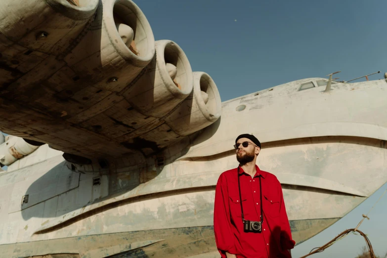 the man is standing in front of a large object