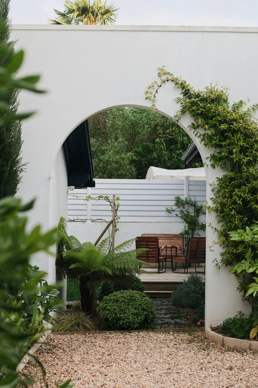 a white building that is surrounded by many trees