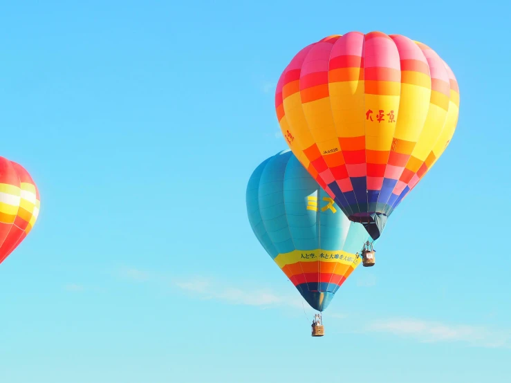 a sky s of three multicolored  air balloons