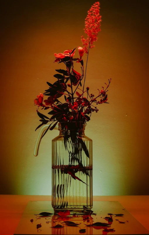 flowers are in the vase in front of a green background