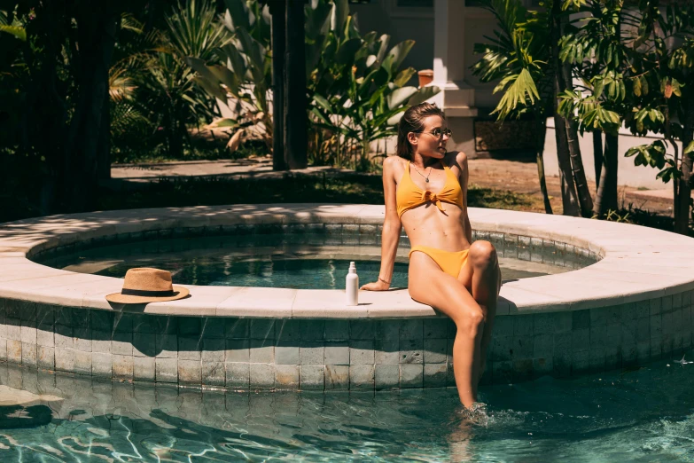 a beautiful woman sitting in the middle of a swimming pool