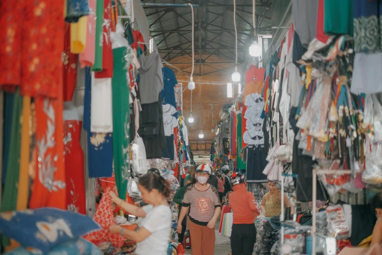 a group of people are shopping for items in a market