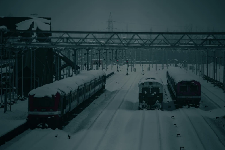 trains are traveling in the winter with snow