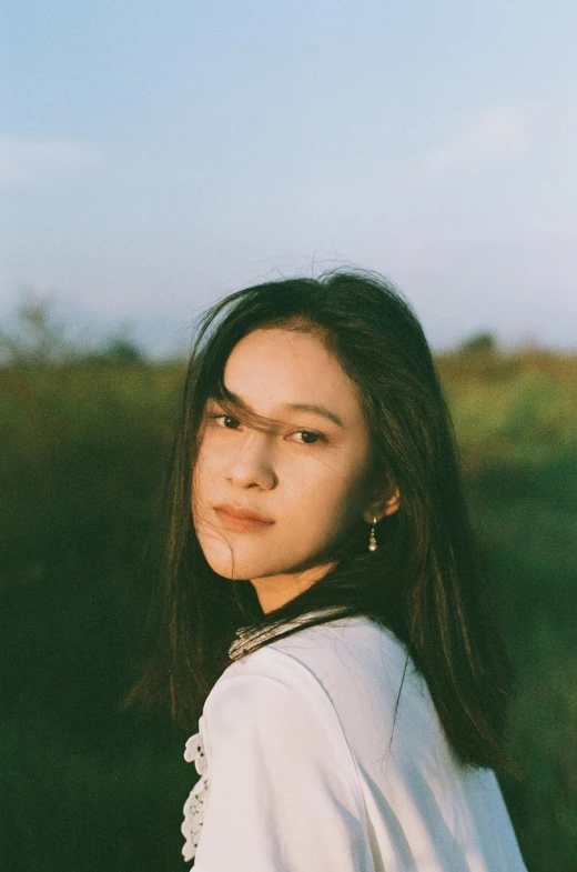 a girl wearing white has long black hair