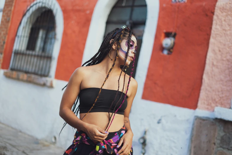 a girl that is standing outside near a building