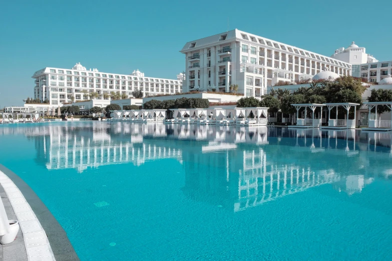 an elaborate swimming pool is in front of the resort