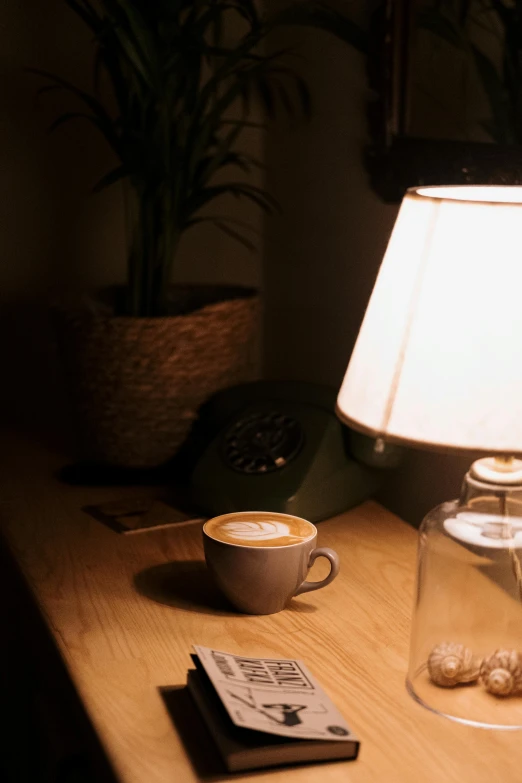a lamp that is on a table next to a book
