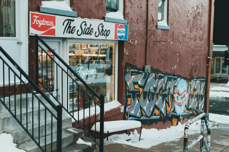 there is a building with many signs and snow on the ground