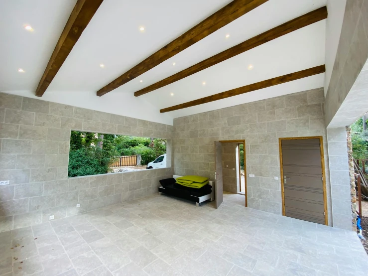 the inside of a large home with tiles and beams