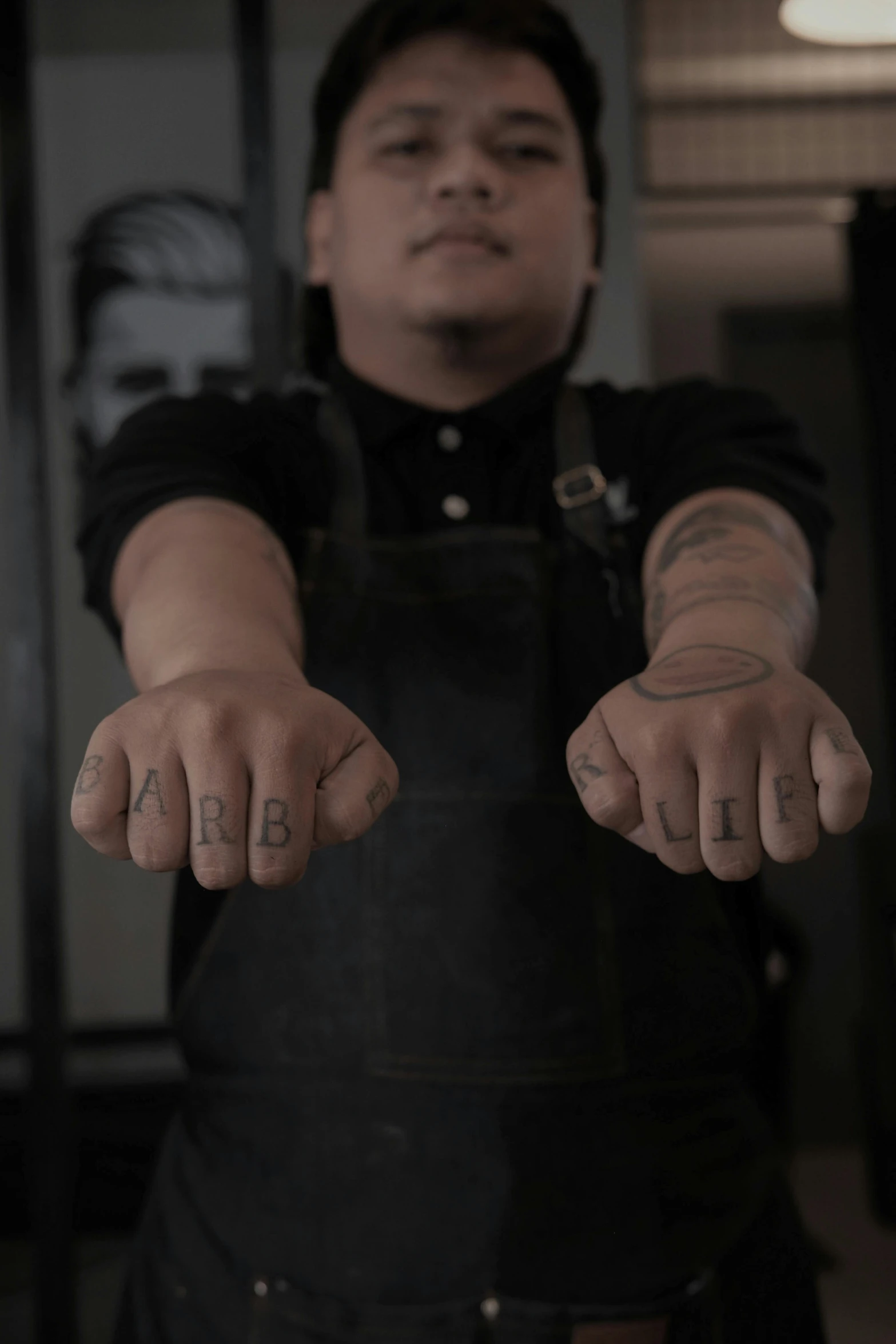 a man holding out his hands with a tattoo