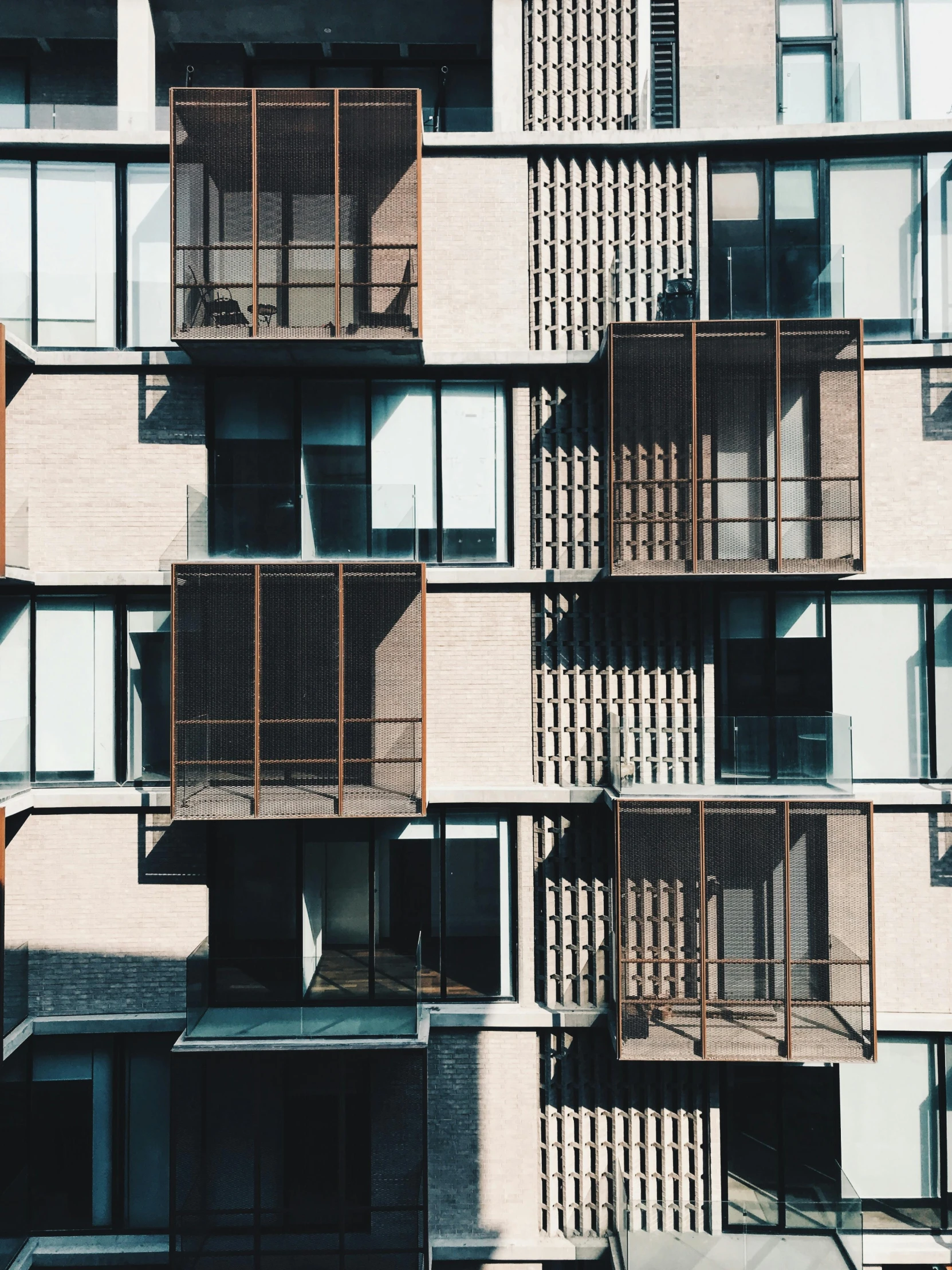 a very tall white brick building with balconies