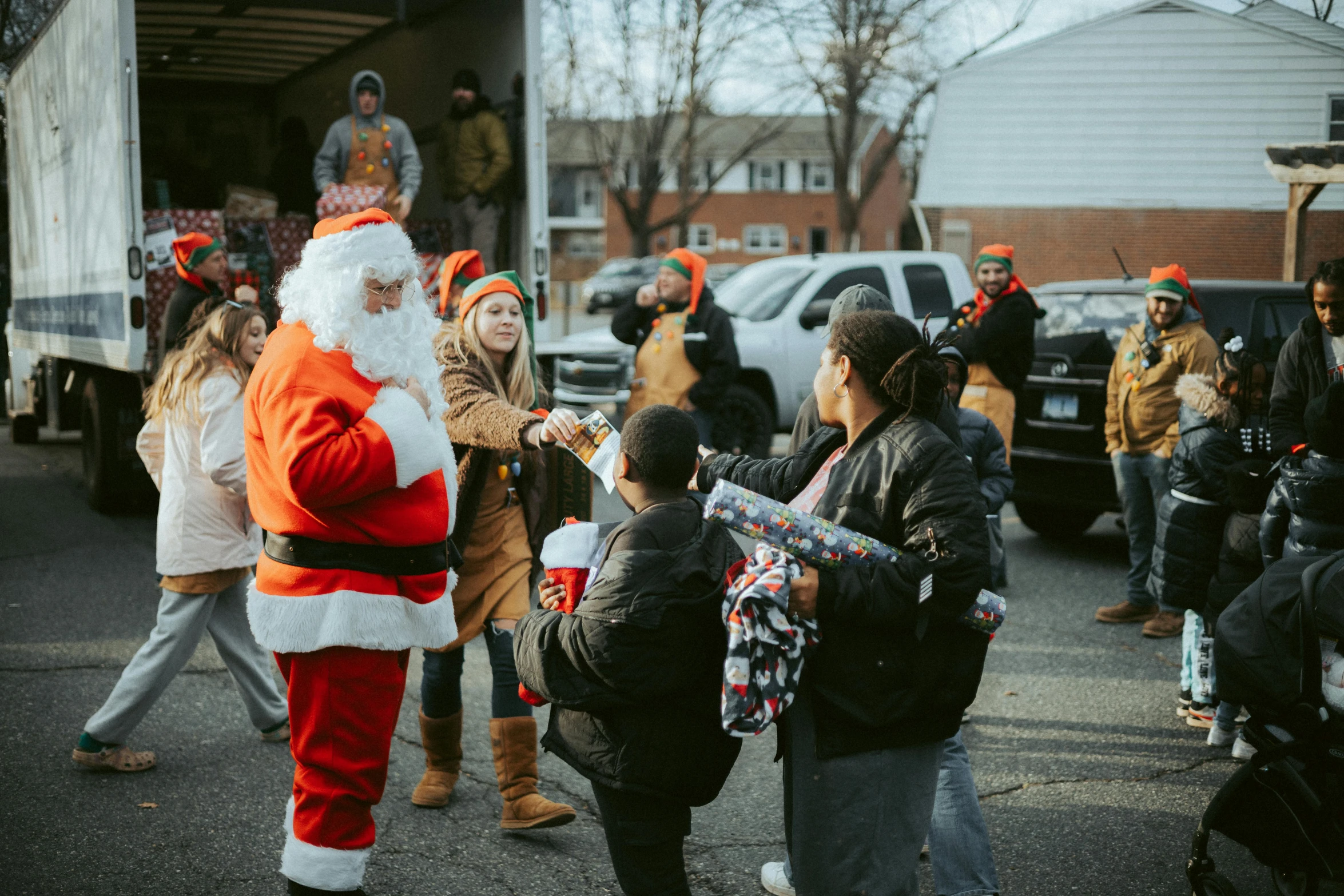 people in costumes taking pictures with santa claus