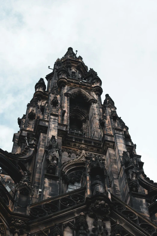 an old building has a tower with carvings on it