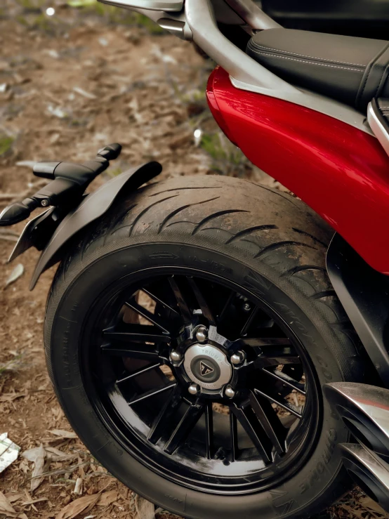 close up of a parked motorbike with a chain attached to the seat