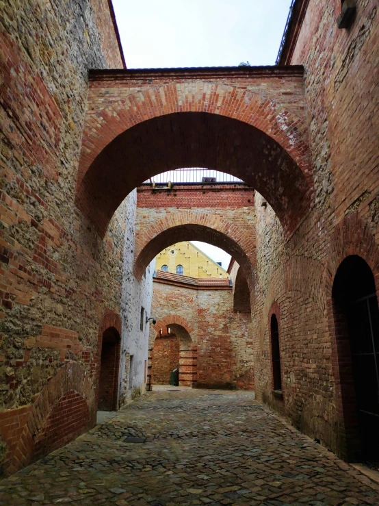 the brick walkway has two arches and some archways