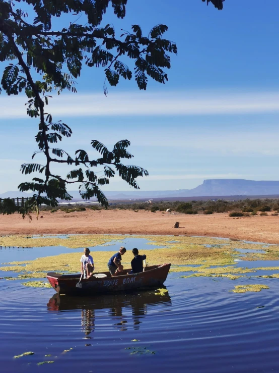 people in a canoe on water near the shore