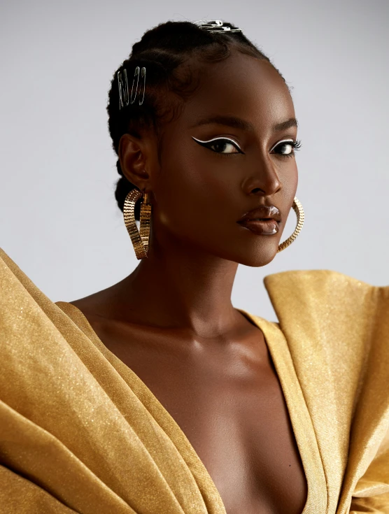 an african woman with large gold hoop earrings on her head