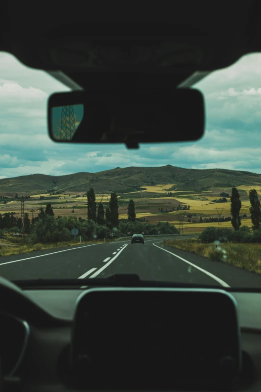 a long highway going through a rural landscape