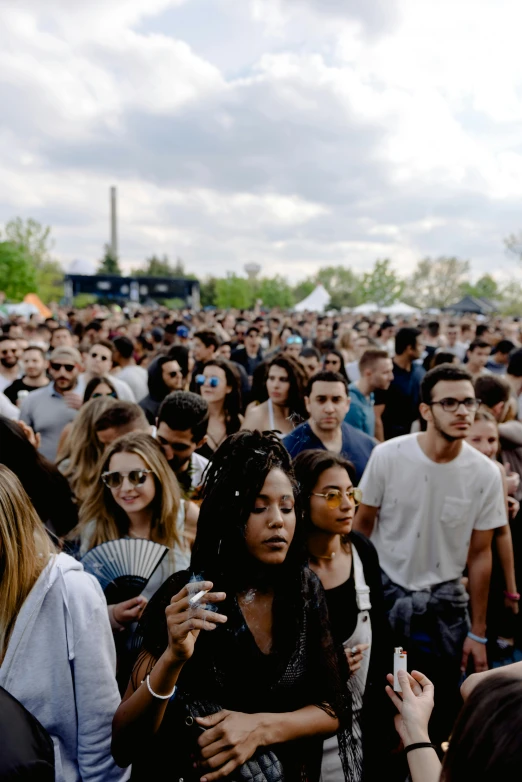 a crowd of people standing around each other