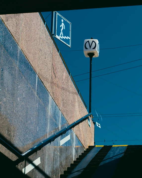 a tall brick wall next to some street signs