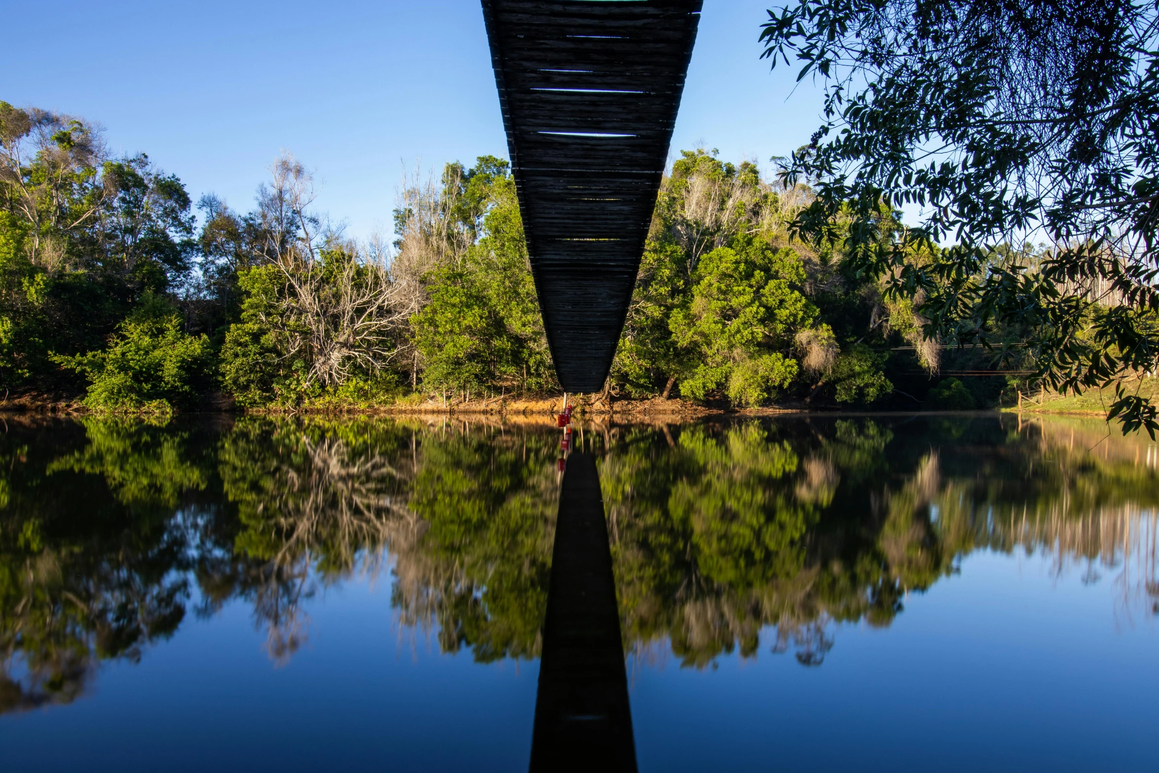 a bridge is reflecting on a body of water