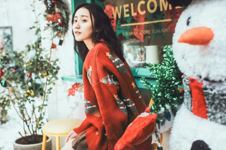 a woman with long hair is standing in front of a snowman