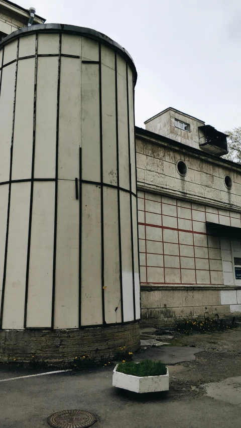 a large white tank is next to a building