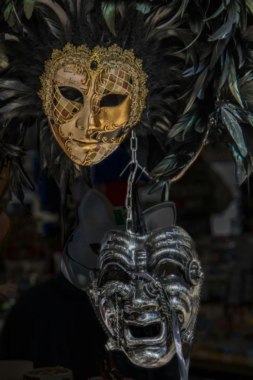 a person wearing a silver mask with golden metal decorations