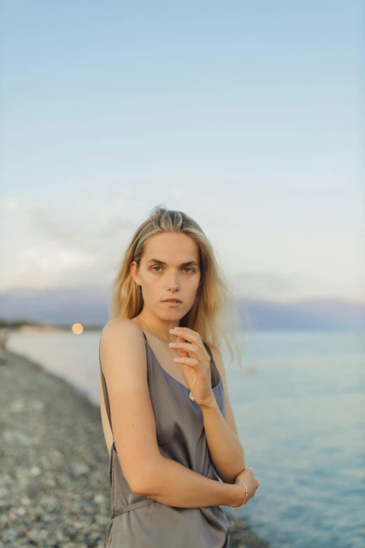 a woman is standing on the edge of the water