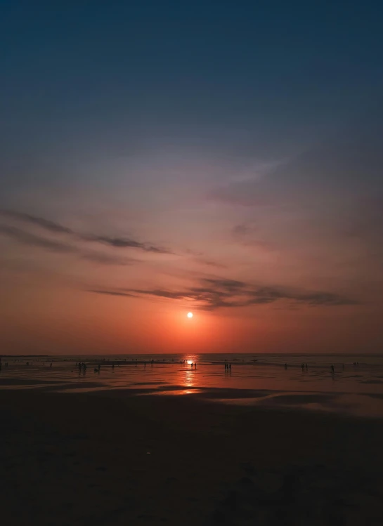 a view of a setting sun from a beach