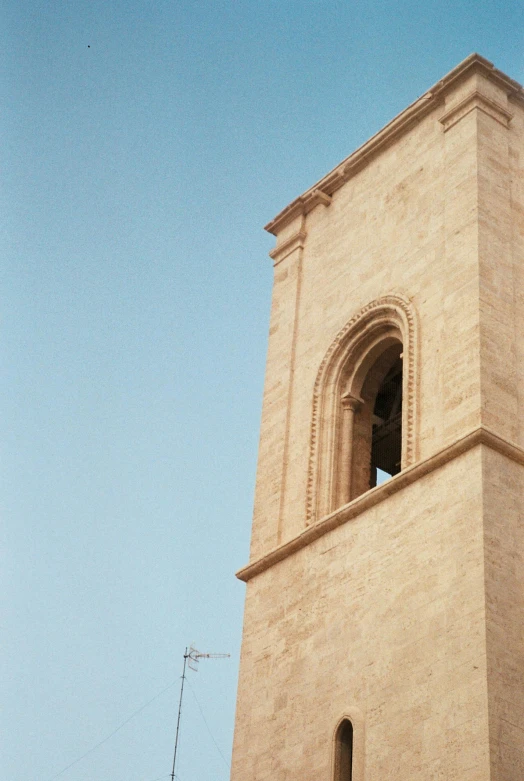 the clock tower is set high in the blue sky