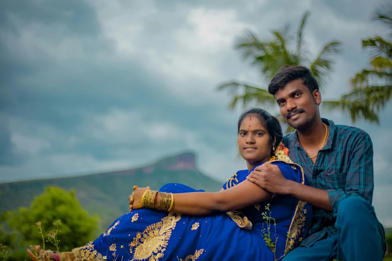 a man and woman posing for a picture in a field