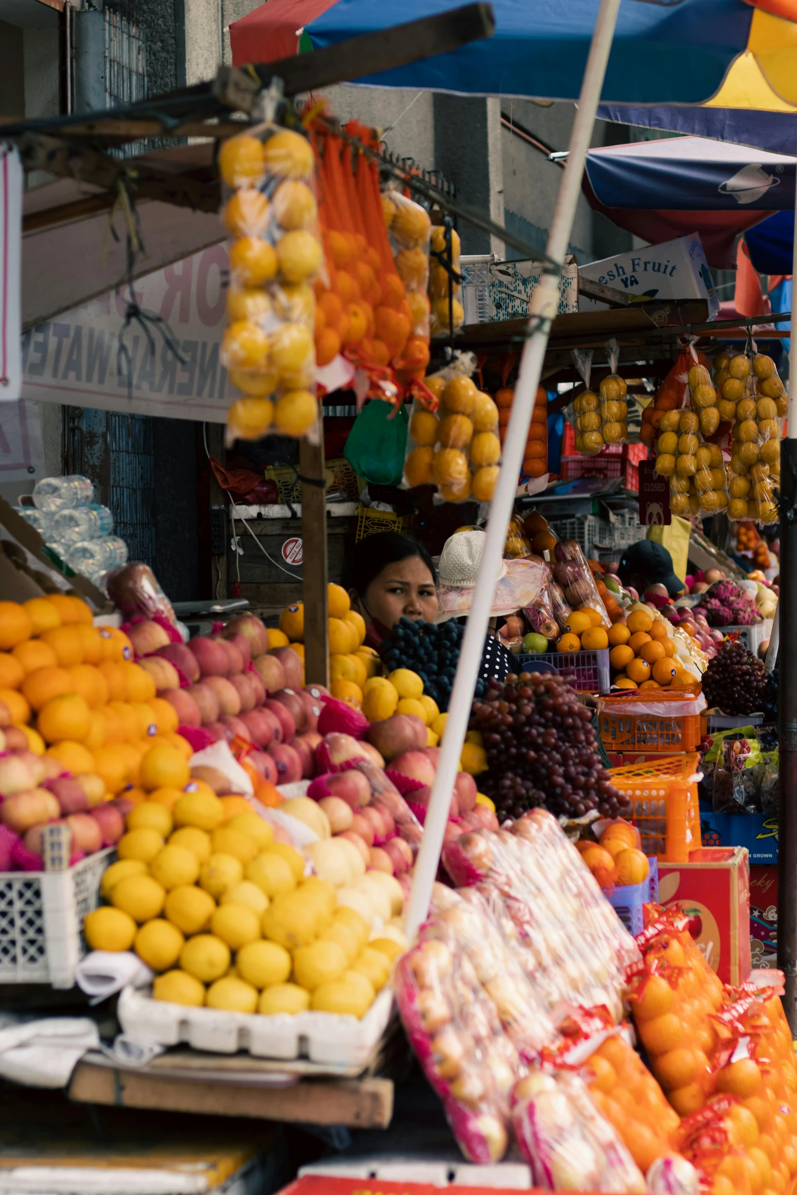 a fruit stand displays lemons, oranges and other fruits