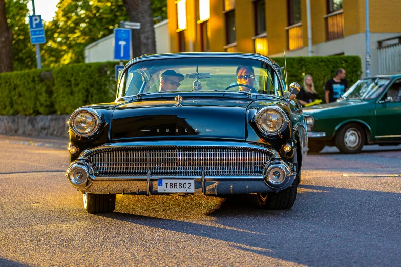 an old model car on a street