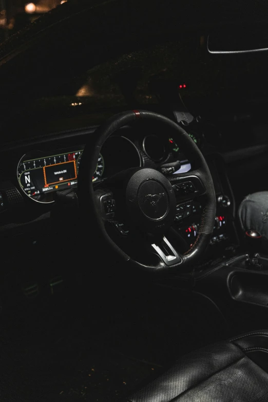 a po of a car dashboard at night with light shining on it