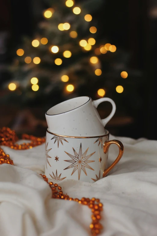 the coffee cup has gold snowflakes on it