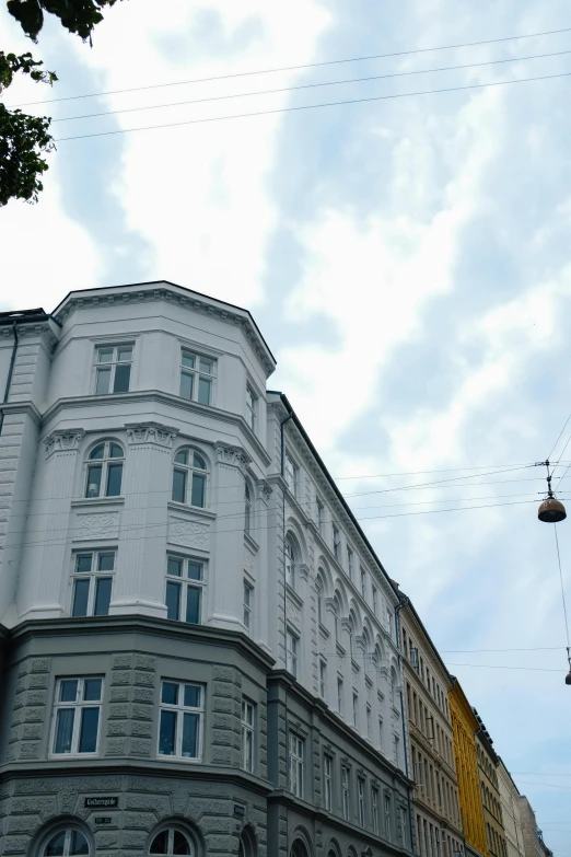 a very tall building on the corner of a street