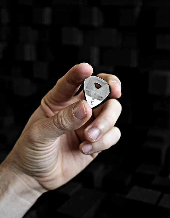 a person holding a piece of silver metal