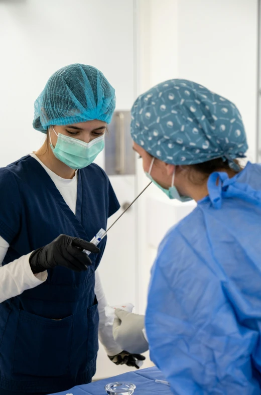 two surgeons are performing a  in an operating room