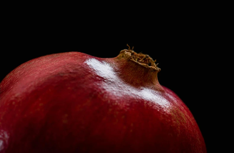 an image of a single pomegranate that has some small chunks