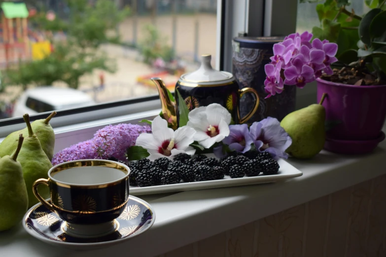 tea and fruit set in front of the window