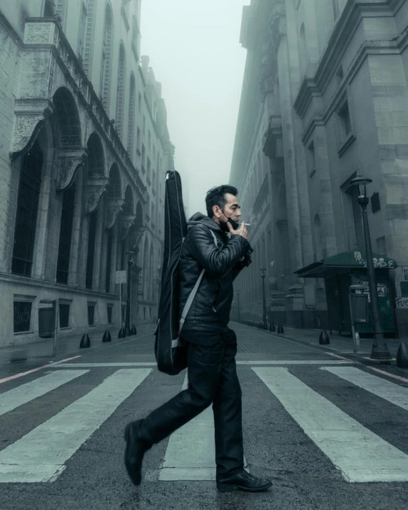 a man walking on a street while talking on a cell phone