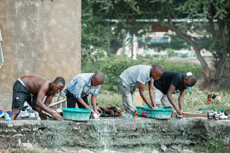 people scoop up garbage at the street