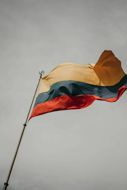 an orange, blue and black striped flag flying in the wind