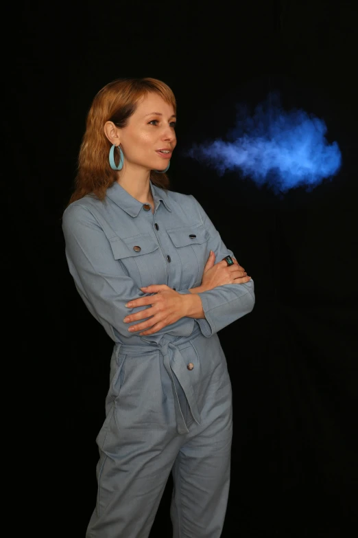 a woman that is standing in front of a black background