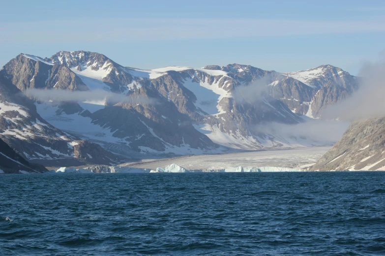 the mountains are covered in white and brown snow