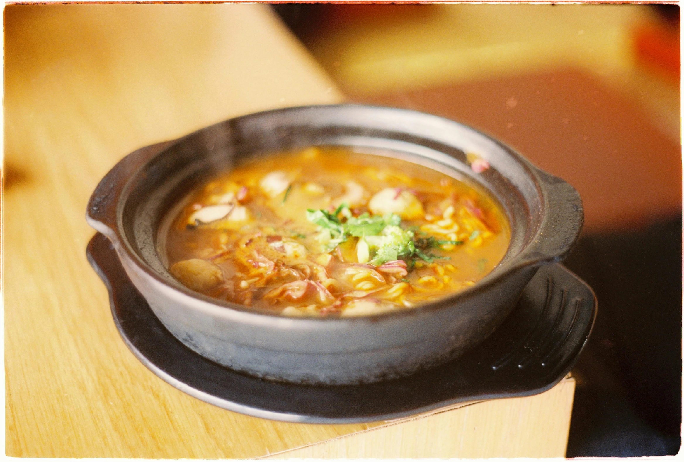 a bowl of soup with broccoli is shown